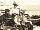 They are sitting in a car made by Minerva voiture Minerva